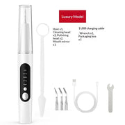 White ultrasonic dental scaler with black control panel and interchangeable metal cleaning heads.